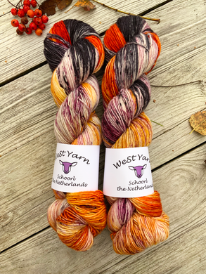Two luxurious hand-dyed yarn skeins in vibrant amber colorways from WeStYarn, Netherlands. Perfect for premium knitting and crochet projects.
